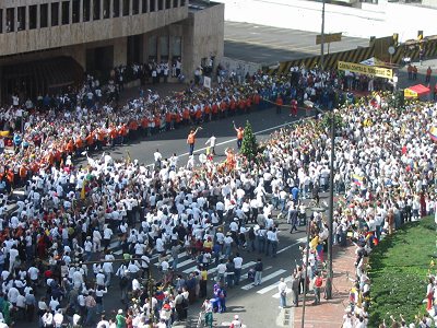 People singing and marching in the street, protesting terrorism