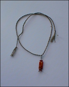 Greeny grey floss, stainless steel wire and red glass beads.