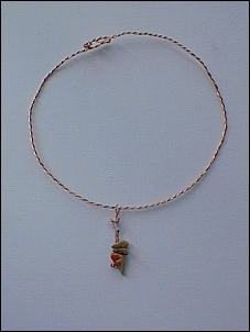 Twisted copper wire, polished quartz bead and polished oyster shell.