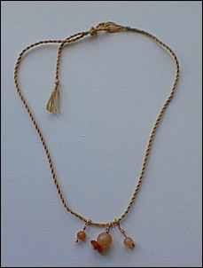 Camel floss, polished alabaster beads, copper wire.